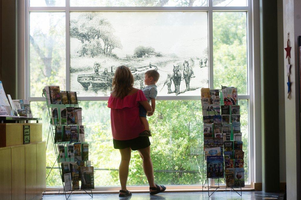 women with small child looking at an exhibit at the Port Byron Erie Canal Museum